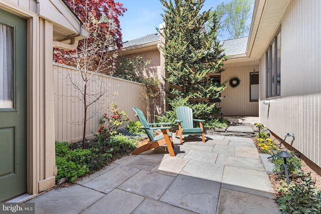 view of patio featuring fence