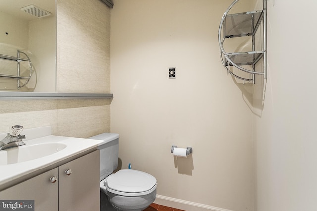 bathroom with baseboards, visible vents, toilet, and vanity