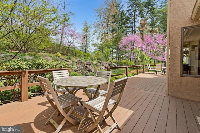 wooden deck with outdoor dining space
