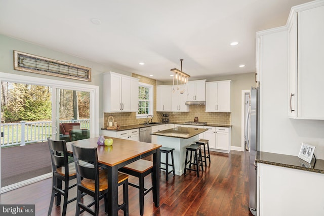 kitchen featuring white cabinets, backsplash, and dark wood-type flooring
