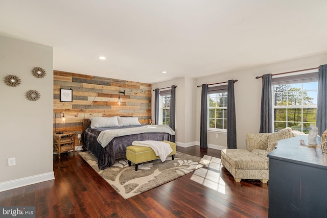 bedroom with wooden walls, recessed lighting, baseboards, and hardwood / wood-style floors