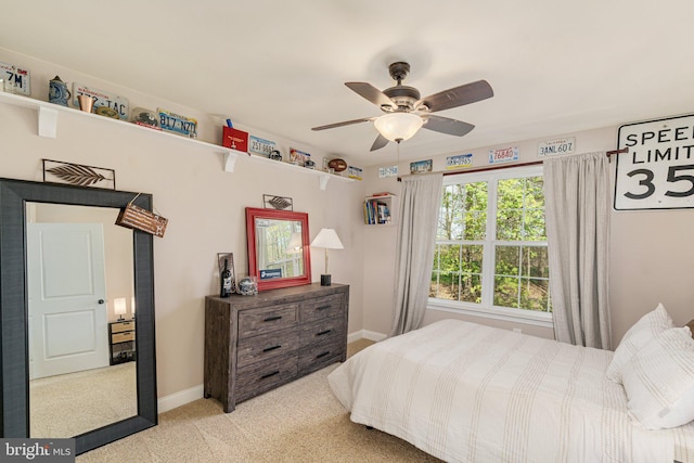 carpeted bedroom featuring baseboards and ceiling fan