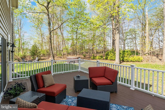 wooden deck featuring a yard and an outdoor hangout area