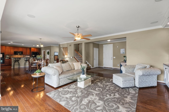 living area with crown molding, ceiling fan, baseboards, dark wood-type flooring, and stairway