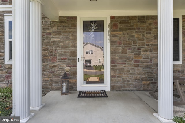 doorway to property featuring stone siding
