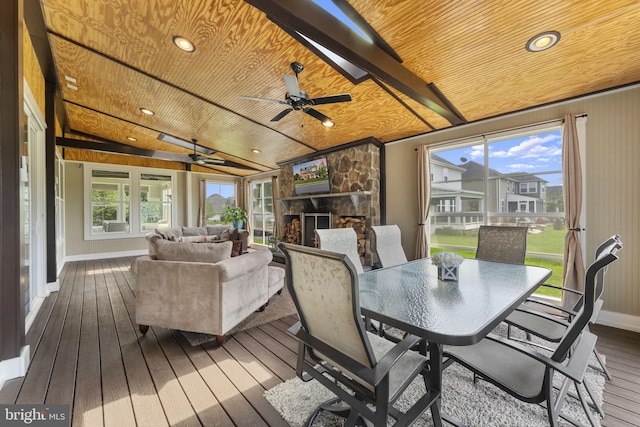 sunroom featuring plenty of natural light and beamed ceiling