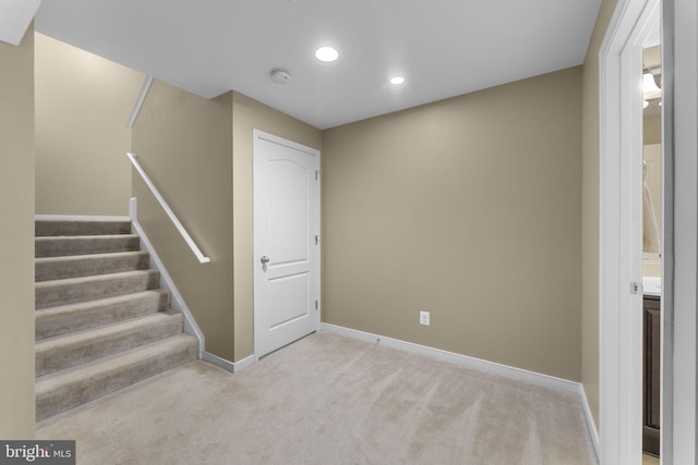 basement featuring baseboards, recessed lighting, stairs, and carpet floors