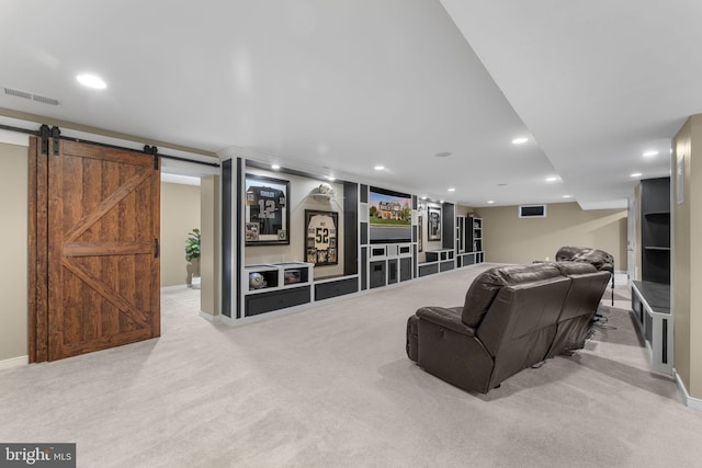 living area featuring visible vents, light carpet, baseboards, recessed lighting, and a barn door