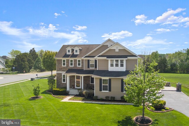 view of front of house featuring stone siding and a front yard