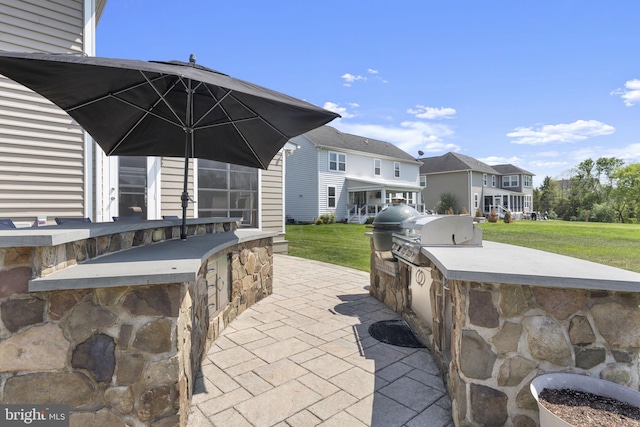 view of patio with a residential view and area for grilling