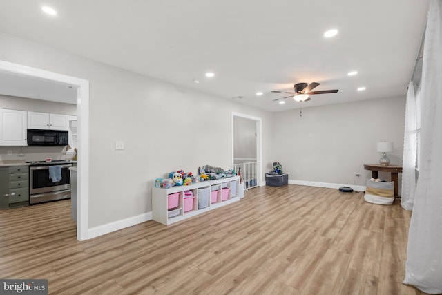 recreation room featuring baseboards, a ceiling fan, light wood finished floors, and recessed lighting