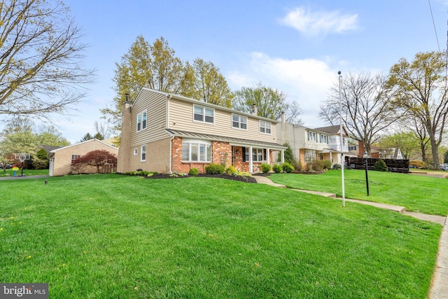 view of front of house featuring brick siding, a chimney, and a front yard
