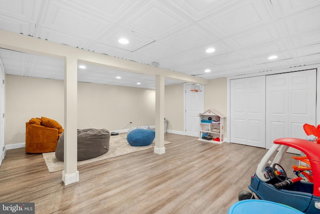 exercise room featuring recessed lighting, baseboards, wood finished floors, and an ornate ceiling