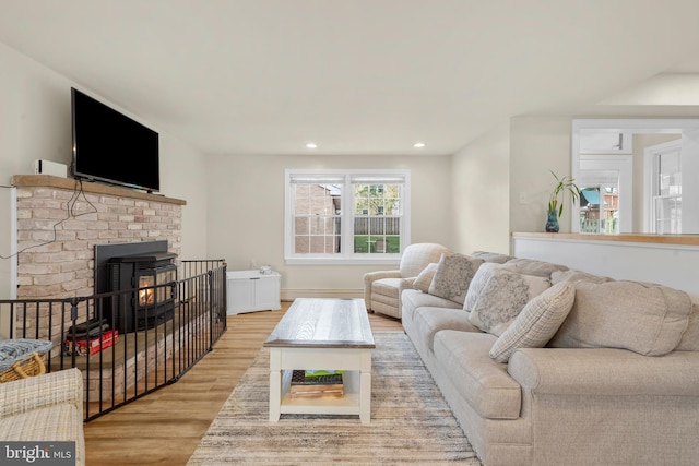 living area featuring light wood-type flooring and recessed lighting