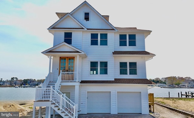 29 Bay Way, Brick, NJ 08723 - coastal inspired home with stairs, a water view, a shingled roof, and a garage