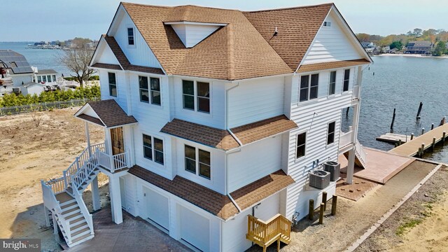 29 Bay Way, Brick, NJ 08723 - view of home's exterior with stairway, a shingled roof, a water view, central air condition unit, and an attached garage