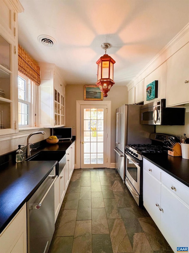 1012 Locust Ave, Charlottesville, VA 22901 - kitchen featuring dark countertops, a sink, a wealth of natural light, stainless steel appliances, and visible vents