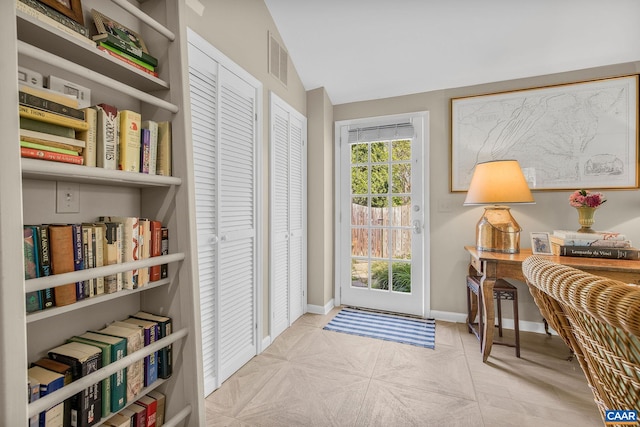 1012 Locust Ave, Charlottesville, VA 22901 - doorway to outside featuring lofted ceiling, baseboards, and visible vents