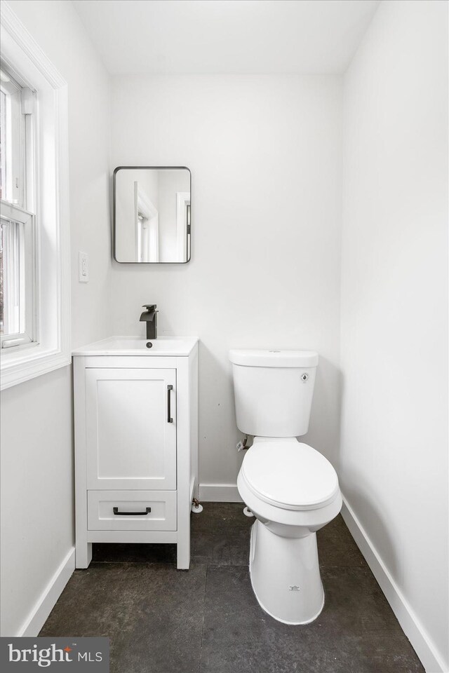 5601 Groveland Ave, Baltimore, MD 21215 - half bathroom with baseboards, toilet, and vanity