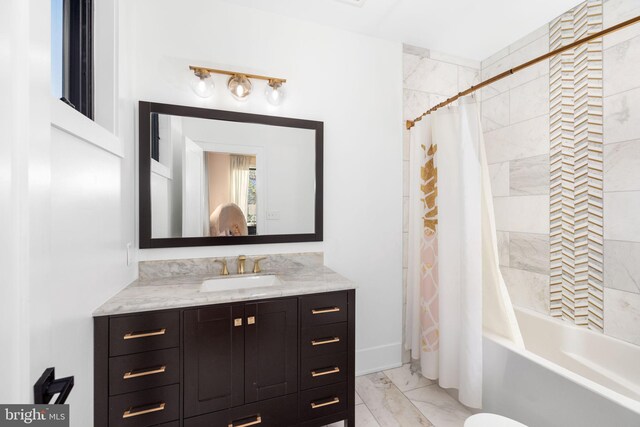 full bathroom featuring shower / tub combo with curtain, marble finish floor, and vanity