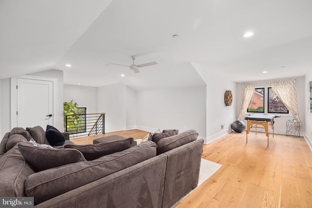 living area featuring ceiling fan, baseboards, light wood-style floors, and recessed lighting