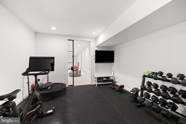 exercise room with recessed lighting and baseboards
