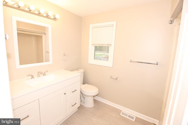 415 Sheppard Ave, Runnemede, NJ 08078 - bathroom with toilet, vanity, wood finished floors, and baseboards
