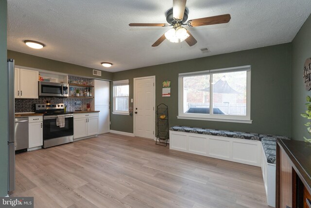 197 Crocus Ct, Quakertown, PA 18951 - kitchen featuring dark countertops, a textured ceiling, white cabinetry, and appliances with stainless steel finishes