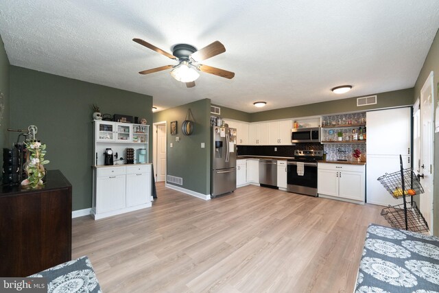 197 Crocus Ct, Quakertown, PA 18951 - kitchen with open shelves, visible vents, appliances with stainless steel finishes, and white cabinets