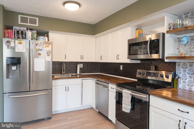197 Crocus Ct, Quakertown, PA 18951 - kitchen with stainless steel appliances, a sink, visible vents, white cabinetry, and open shelves