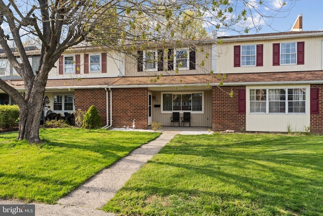 197 Crocus Ct, Quakertown, PA 18951 - view of front facade with a shingled roof, a front lawn, brick siding, and a chimney