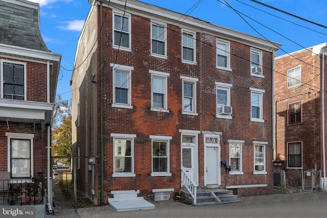 townhome / multi-family property with entry steps and brick siding