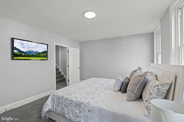 carpeted bedroom featuring baseboards