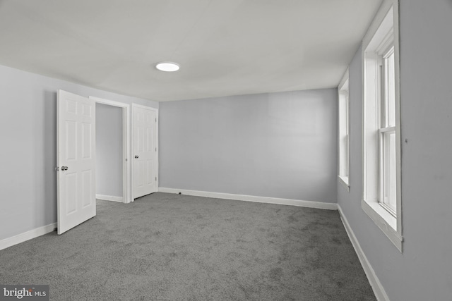 interior space featuring carpet and baseboards