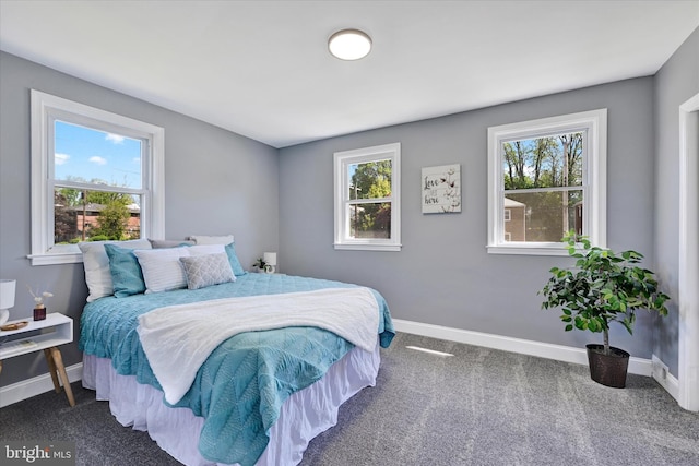 bedroom featuring baseboards and carpet