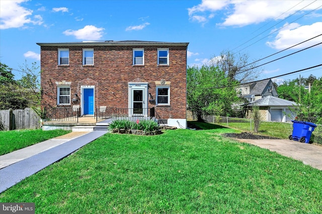 view of front of home featuring fence, a front lawn, and brick siding