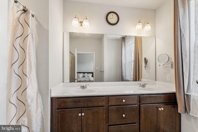 full bathroom with a sink, ensuite bath, and double vanity