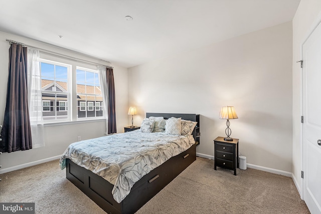 carpeted bedroom featuring baseboards
