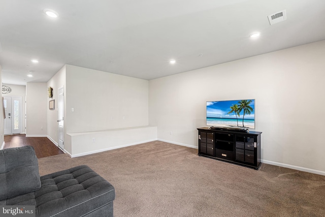 unfurnished living room with recessed lighting, baseboards, visible vents, and carpet