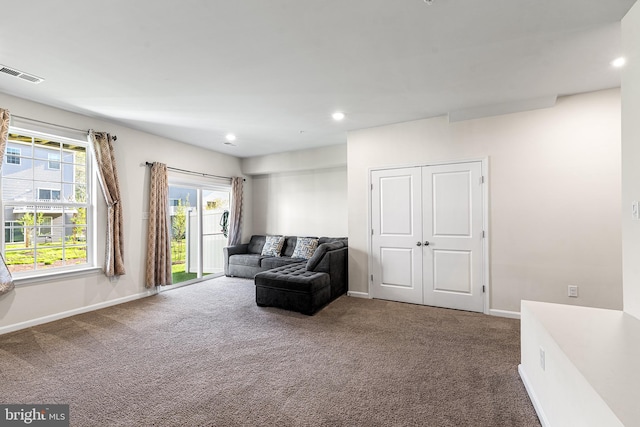 carpeted living room featuring baseboards, recessed lighting, and visible vents