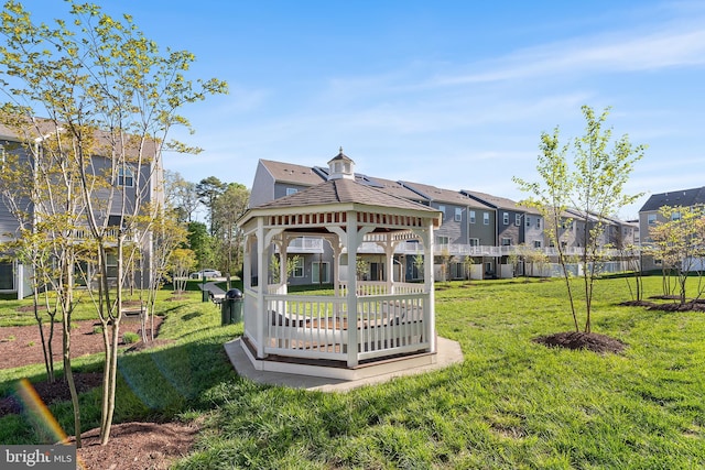 view of property's community featuring a residential view, a gazebo, and a yard