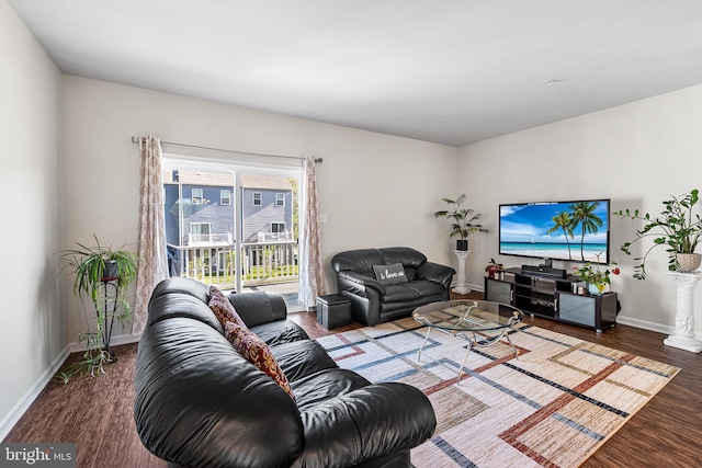 living area featuring baseboards and wood finished floors