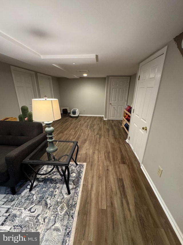 living area with wood finished floors and baseboards