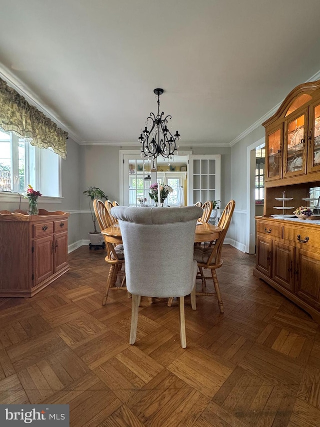 dining room with a wealth of natural light, a chandelier, and baseboards