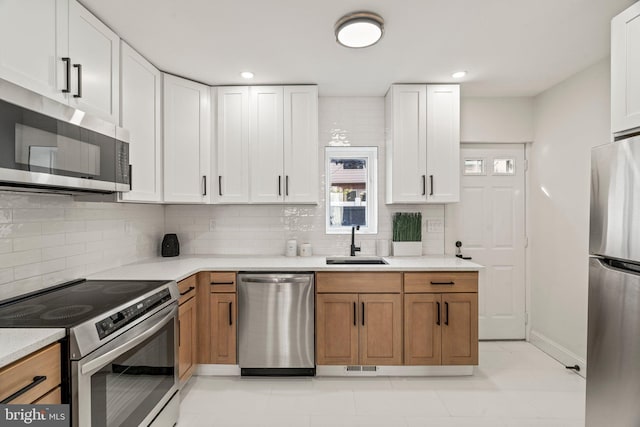 1102 Mercy St, Philadelphia, PA 19148 - kitchen with light countertops, tasteful backsplash, appliances with stainless steel finishes, and a sink