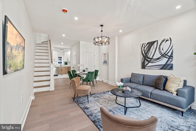 1102 Mercy St, Philadelphia, PA 19148 - living room featuring stairs, a chandelier, light wood-style floors, baseboards, and recessed lighting
