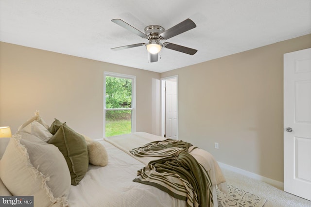 bedroom with light carpet, baseboards, and ceiling fan