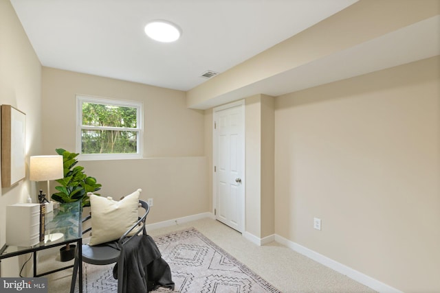 office area with baseboards and light carpet