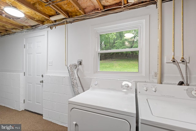 laundry room with washing machine and dryer and concrete block wall