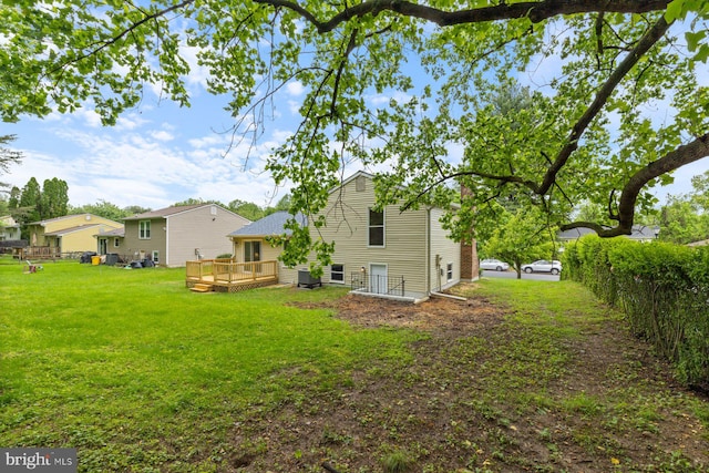 back of house with a wooden deck and central AC unit